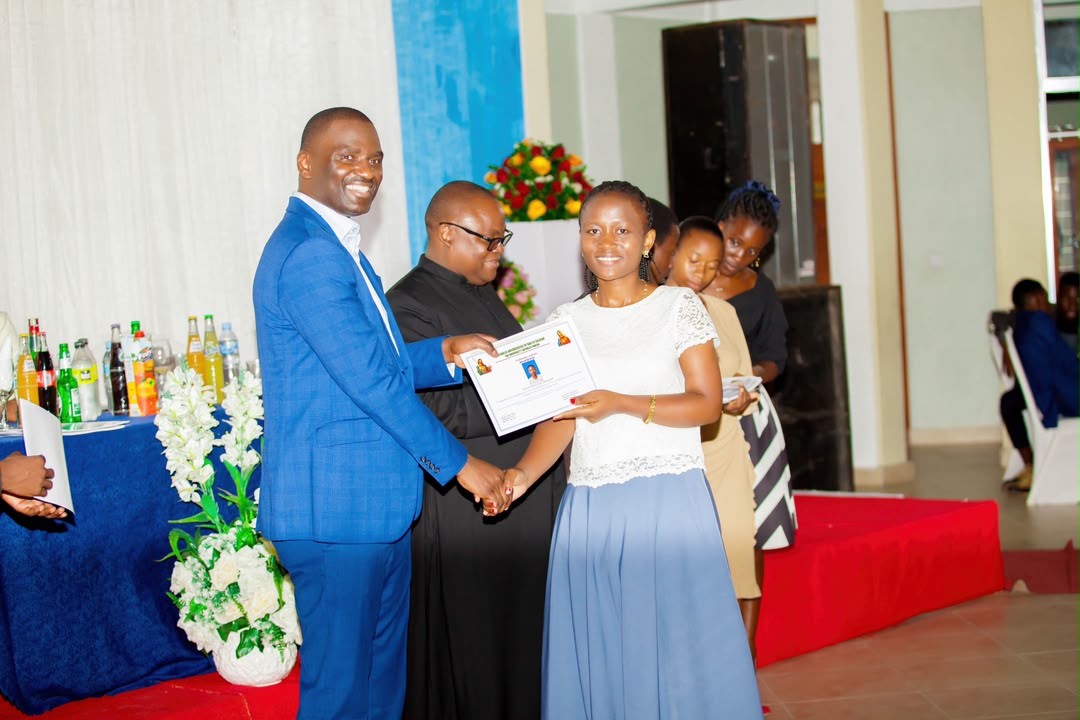 Professional smiling while holding a newly received certification folder at an official milestone event.