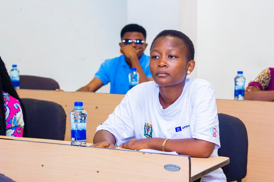 Photograph of the user participating attentively in a UDSM workshop about gender awareness