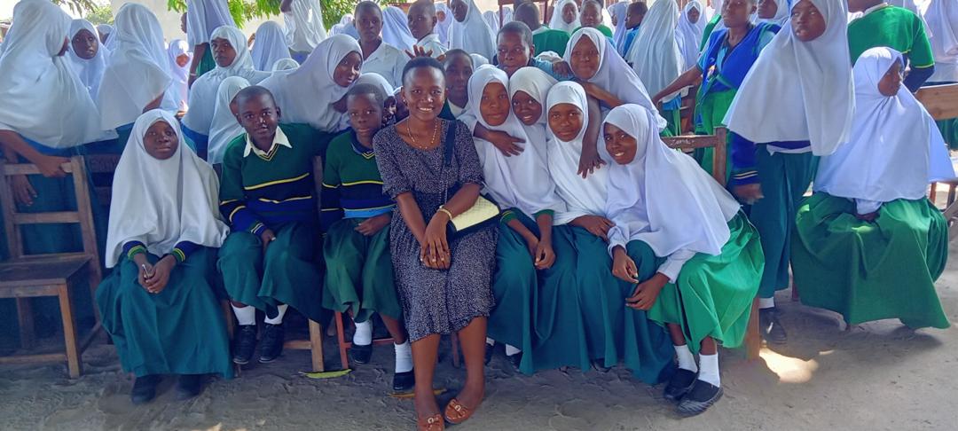 A person actively participating in a gender awareness program with pupils at Upili Kisiju Primary School in Mkuranga District.