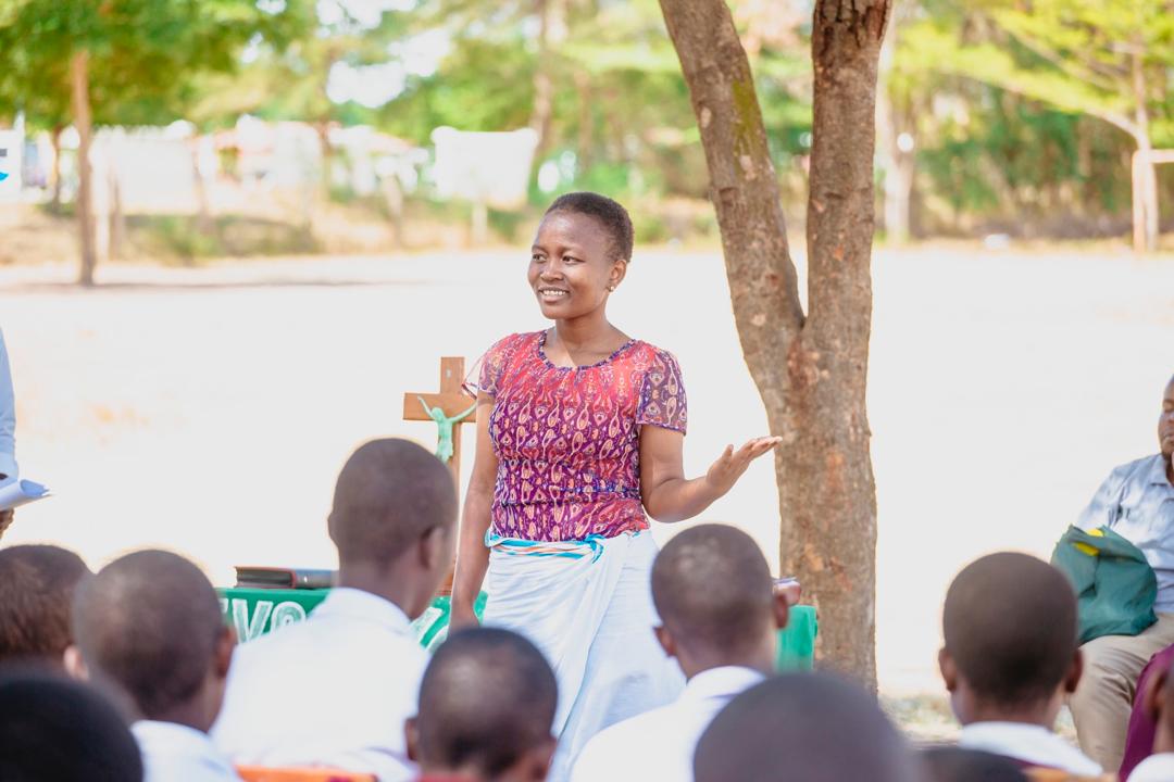 A person conducting a youth mentorship and leadership seminar for students at a school in Bariadi, Simiyu.