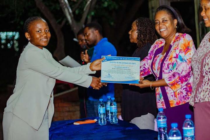 A close-up or presentation photograph of an official certificate from Dr. Lulu Mahai certifying the recipient as an active Gender Club Champion.