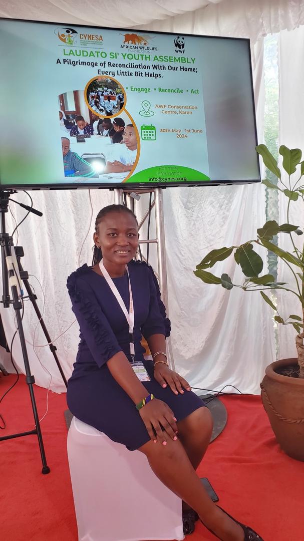 An environmental advocate sitting and engaging attentively during the Laudato Si' Youth Assembly sessions in Nairobi, Kenya.