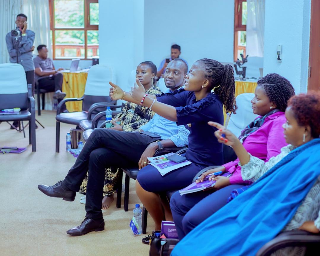 A passionate public speaker addressing a workshop audience with expressive emotion during a child development seminar by Arigatou International
