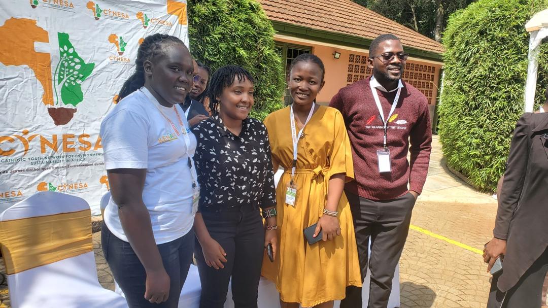 A group portrait of climate advocates including Elizabeth Wathuti smiling together during a collaborative climate action workshop in Nairobi, Kenya.