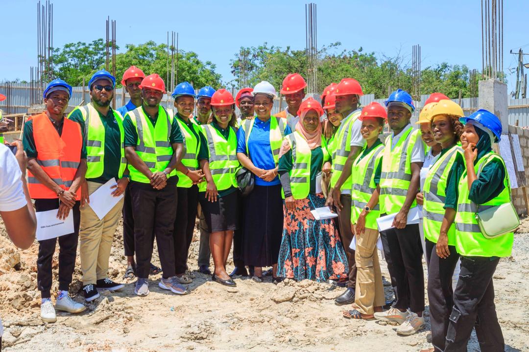 An advocate wearing safety gear while touring the construction site of the UDSM GBV One-Stop Center.