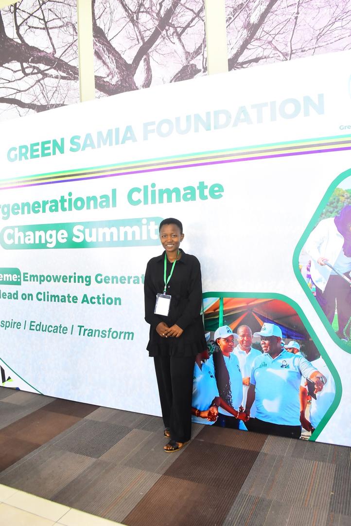 An environmental advocate engaging in cross-generational policy discussions during the Green Samia Foundation climate summit at Mlimani City Conference Centre.